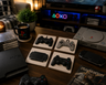 Retro controller coasters styled in a PlayStation gaming room