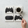 Retro controller coasters on marble with a cup of coffee