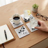 Vintage cartoon coasters on a desk with coffee and glasses